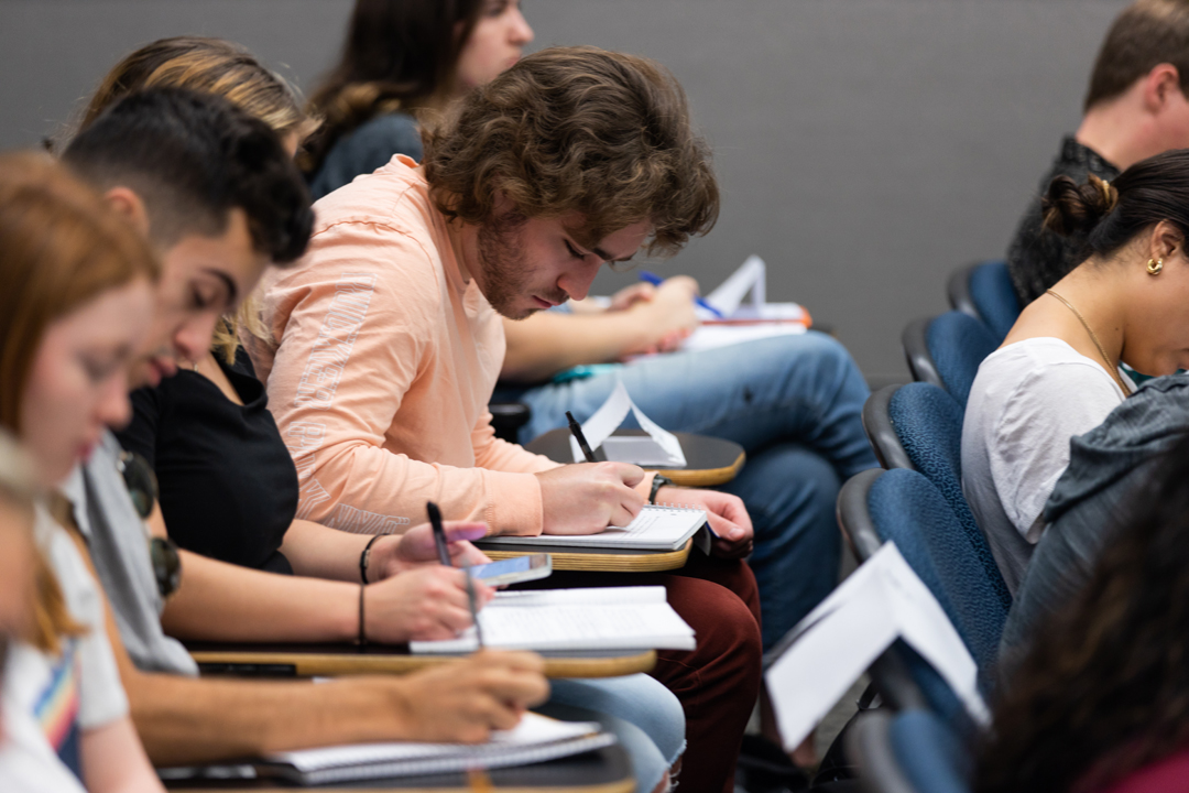 Students writing at desks in a Politics of Russia class