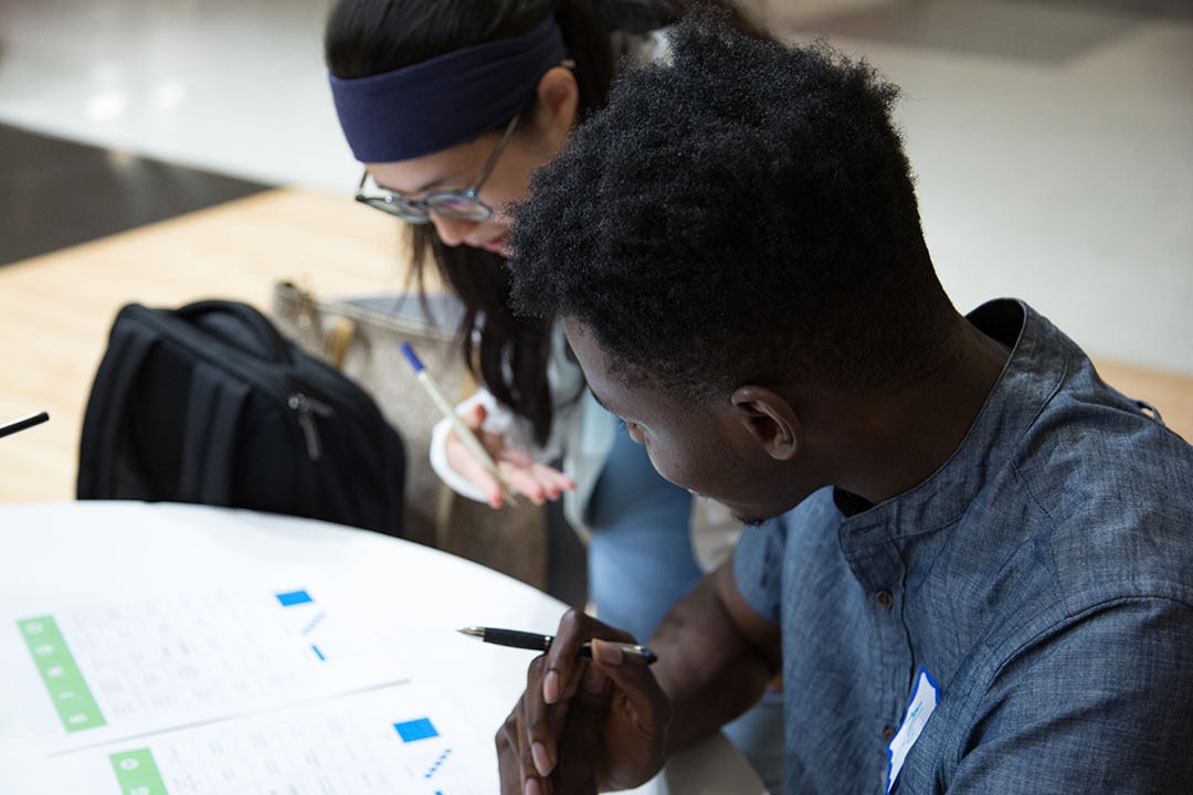 Two students working together over a worksheet