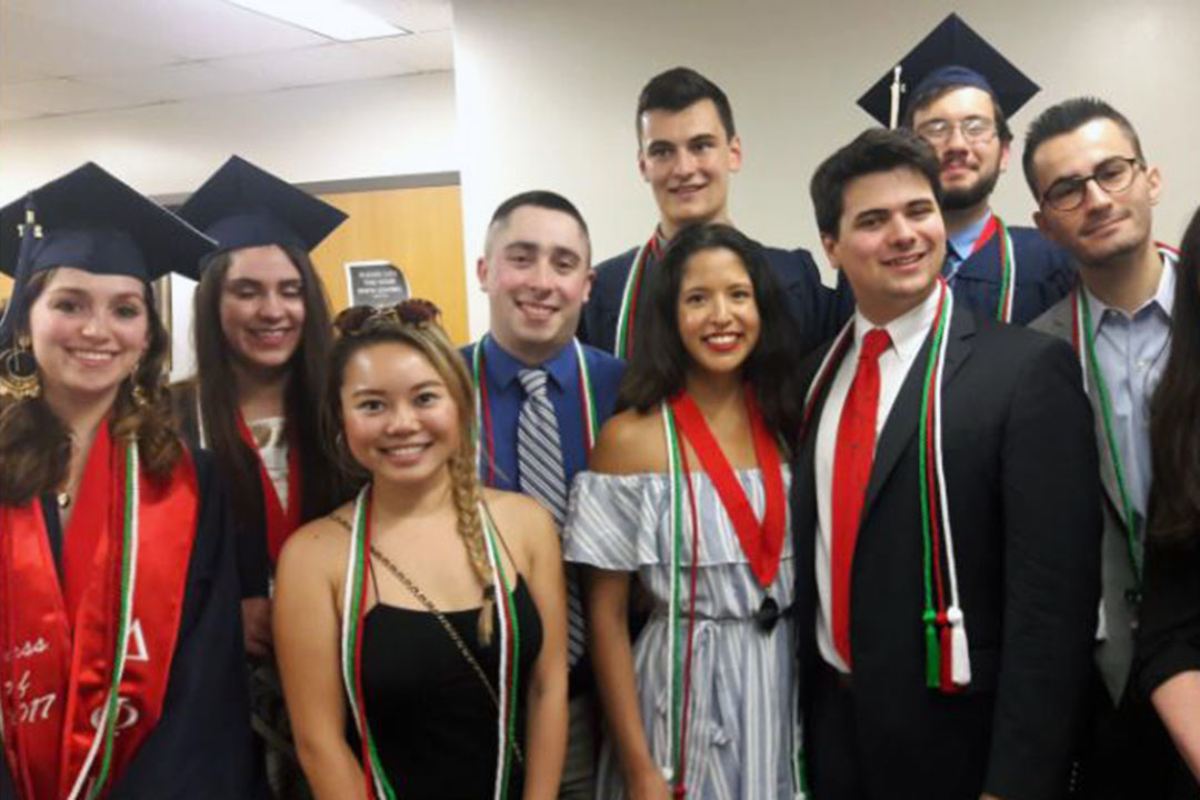 A group of Italian minor students wearing graduation caps and gowns