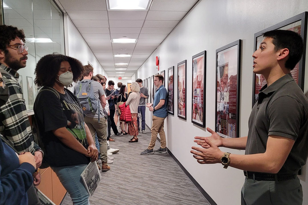  German 4175 students present their final projects to students in a hallway