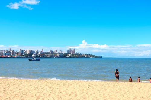 People at the shore of a beach in Mozambique under a blue sky