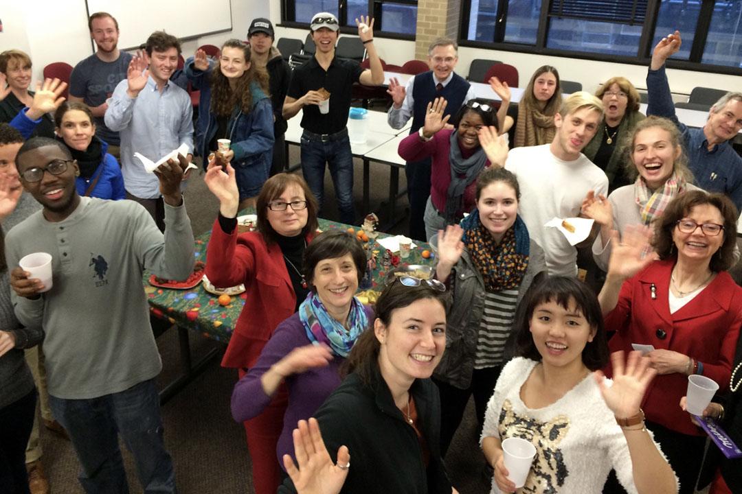 Large group of German students and professors waving